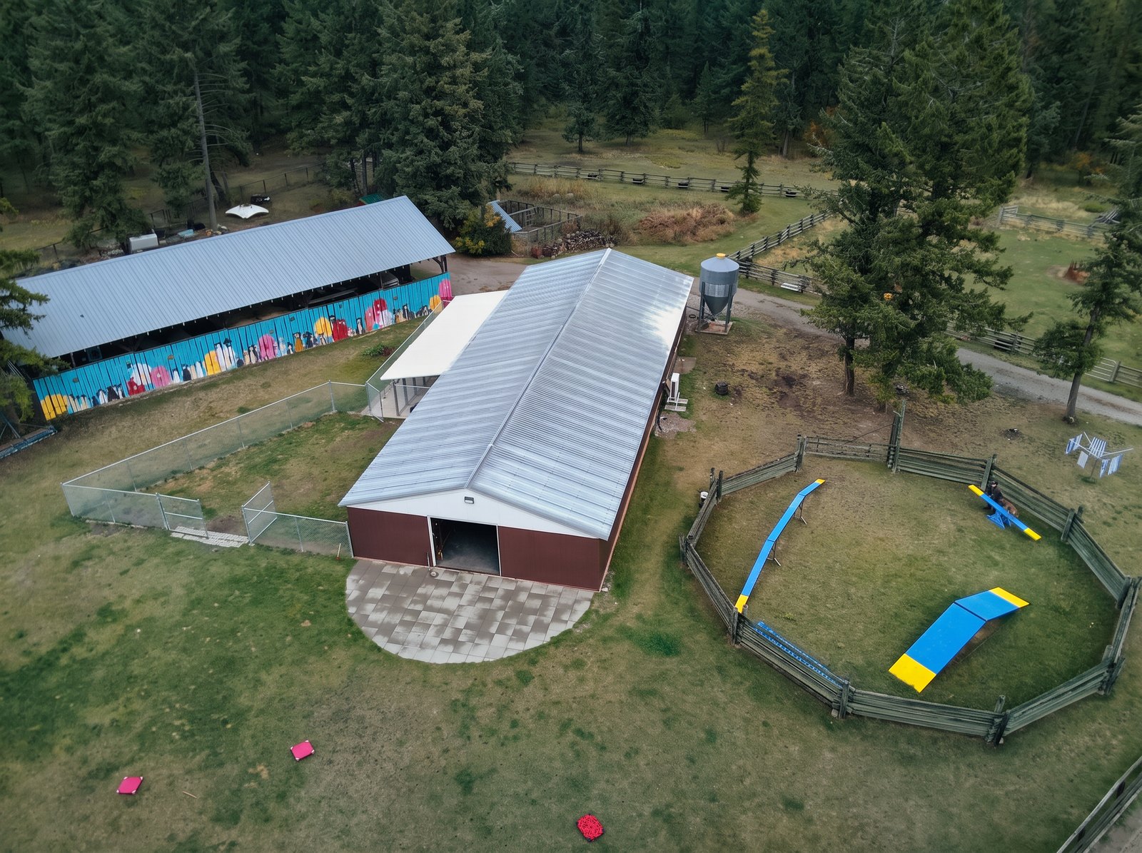 Aerial view of the K9 Basecamp building and adjacent fenced agility training area